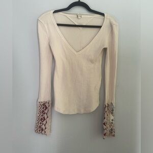 Free people white long sleeve shirt with design on the end of the sleeve